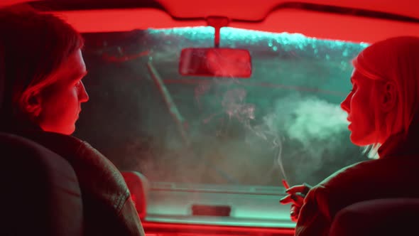 Couple Smoking Cigarette in Car alt