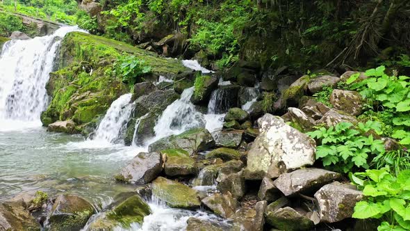 Mountain River Waterfall Flowing Between Rocky Shores in Carpathians Mountains Ukraine alt