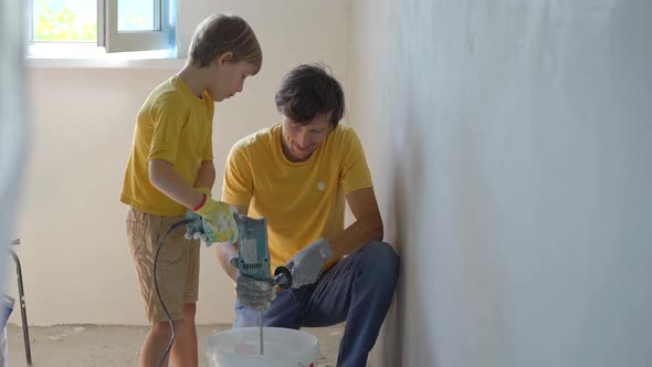 A Young Man and His Son are Doing a Walls Renovation in Their Home alt