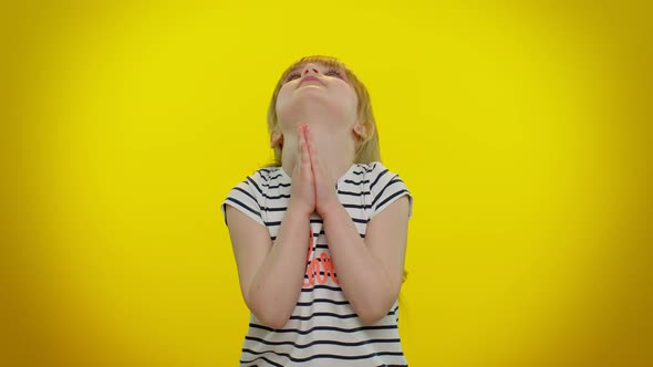 Child Girl Sincerely Praying to God and Looking Up with Pleading Expression Begging Apology Help alt