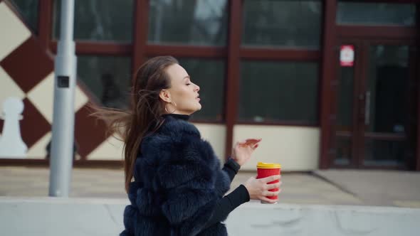 Beautiful sensual girl with dark hair wearing luxurious fur coat alt