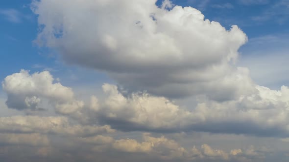 Time Lapse Footage of Fast Moving White Puffy Clouds on Blue Clear Sky alt