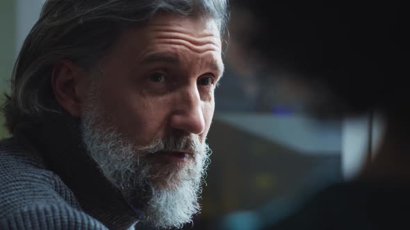 Mature Man Speaking with Colleague alt