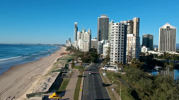 A coastal road leading into a city skyline alt