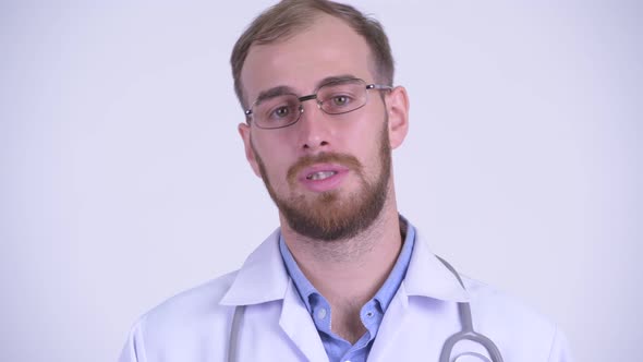 Face of Happy Bearded Man Doctor Talking To Camera