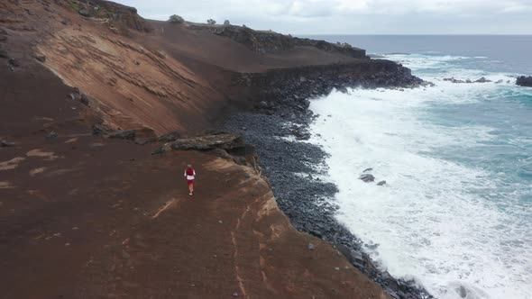 Sporty Man Running on Mountain Road of Capelinhos Volcano Faial Island Azores alt