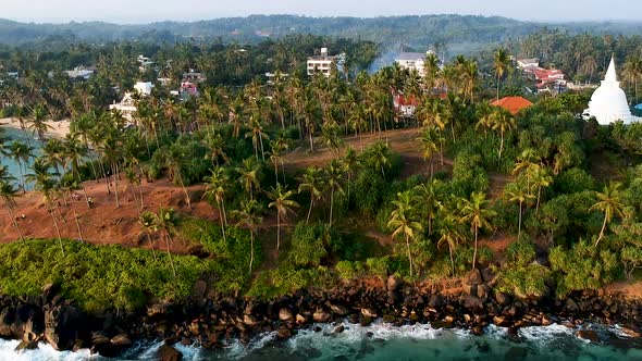 Aerial of Coconut Tree Hill, isolated palm trees. Mirissa, Sri Lanka alt