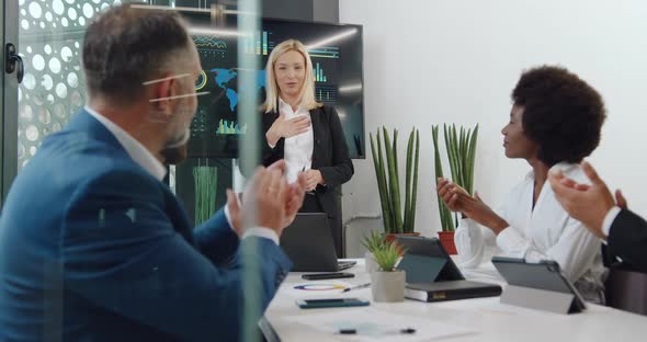 Businesswoman Getting Applause from Satisfied International Colleagues After Presentation alt