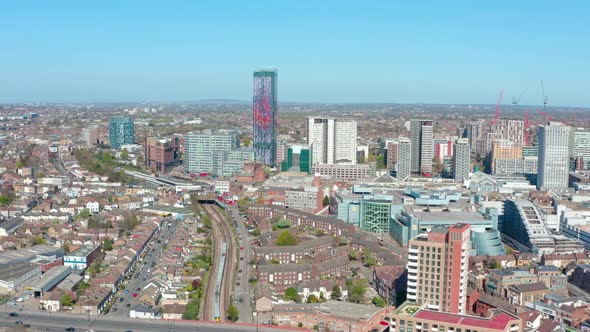 Dolly back drone shot of Croydon London on a sunny day alt