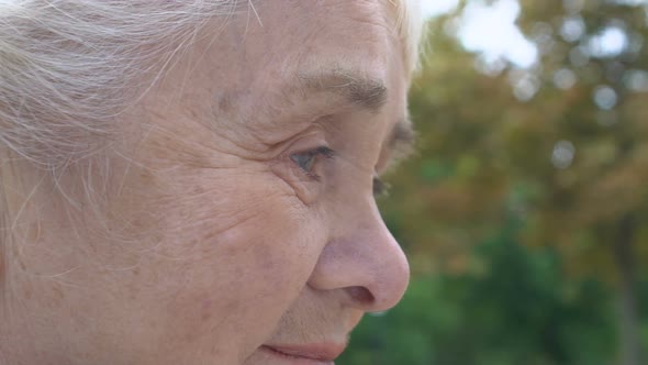 Wrinkled Woman With Hope Smiling and Raising Her Eyes, Happiness at Old Age