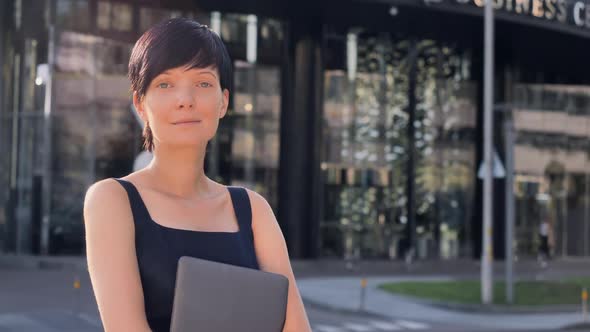 Elegant Brunette Standing in the Morning on the Street alt