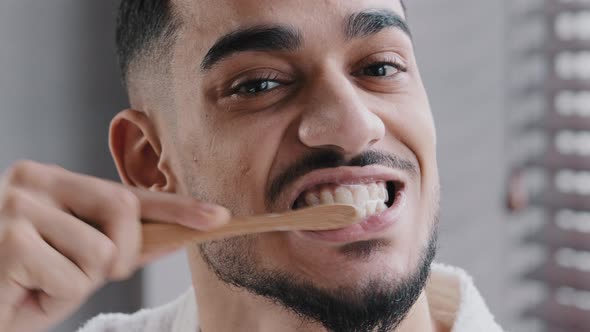 Extreme Close Up Head Shot Bearded Adult Handsome Indian Spaniard Arab Man Brushing Teeth in alt