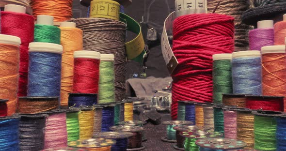 Vintage tailor workshop full of colorful thread on spools. alt