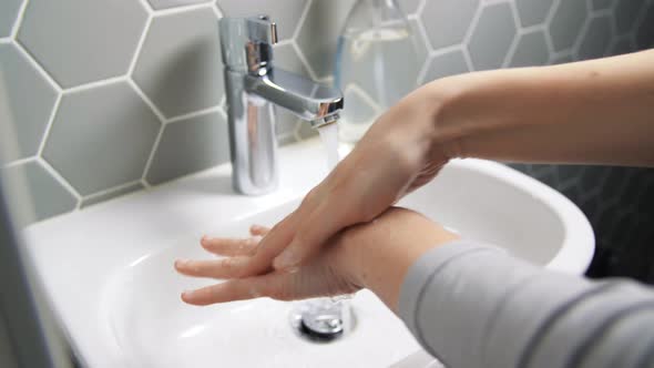 Close Up of Woman Washing Hands with Liquid Soap alt
