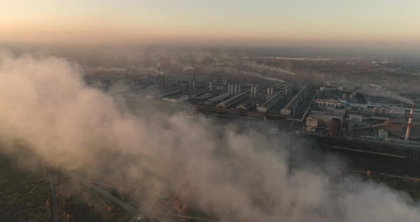 Drone Flying Over Smoking Chimneys of a Steel Factory. Aerial Top View of Metallurgical Plant alt
