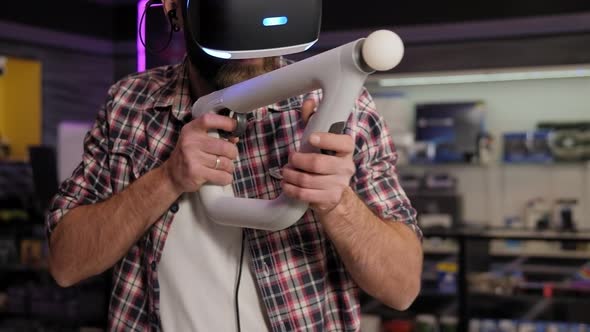 Man Use a Virtual Reality Headset with Glasses and Hand Motion Controllers alt