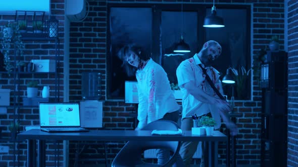 Crippled Creepy Zombies with Bloody Scars Wandering Around Office at Night alt