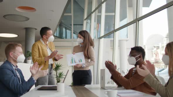 Group of young multiethnic business people working together with facial protection masks and prepari