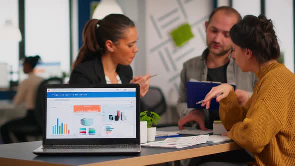 Business Woman Talking About Financial Project Using Laptop alt
