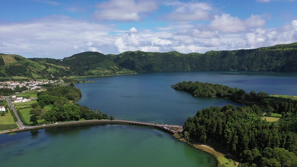 Volcanic crater with blue lake inside. Aerial drone top down flight over, Azores, 4k. alt