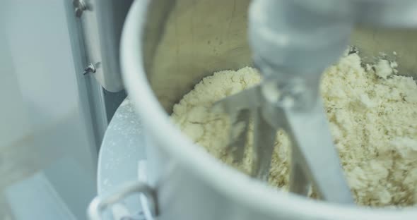 Industrial mixer making dough for cookies in a bakery alt