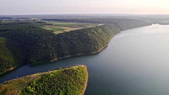 Aerial Drone View on Cliff Mountain Shores Covered with Forest alt