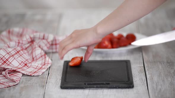 Slicing Strawberries on a Cutting Board