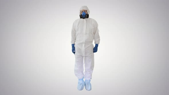 Male Doctor in Hazamat Suit Making Victory Gestures on Gradient Background. alt