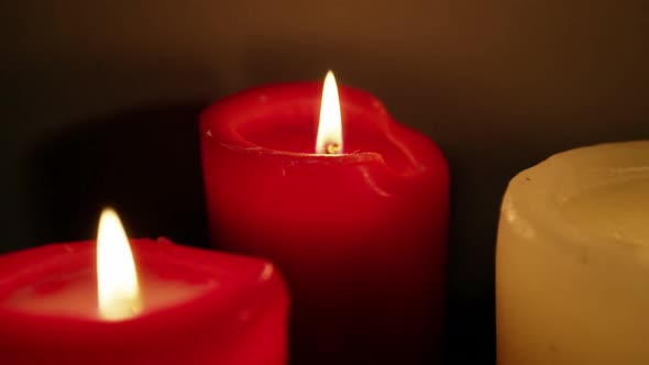 Close-up of candles burning alt