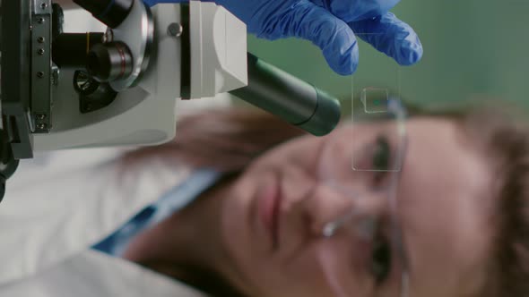 Vertical Video Closeup of Scientist Woman Looking at Test Sample of Lea alt