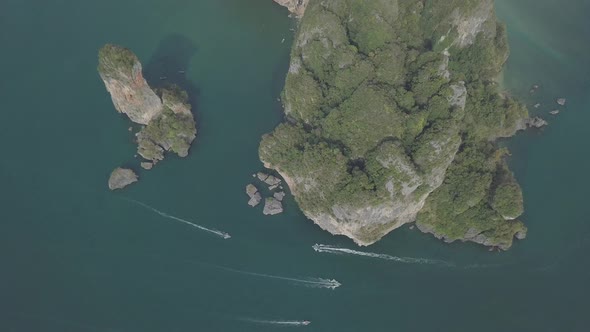 Aerial footage of Ao Nang beach, limestone rocks in sea, sailing boats. Krabi province, Thailand.