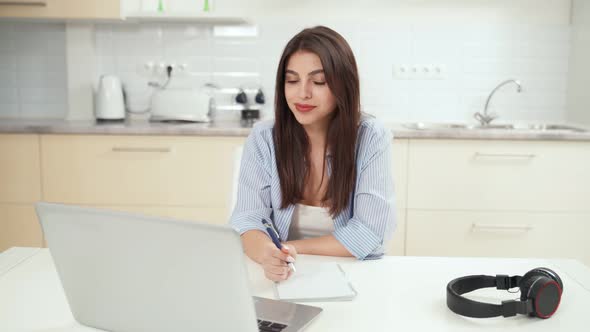 Young Beautiful Woman Studying Online with Laptop alt