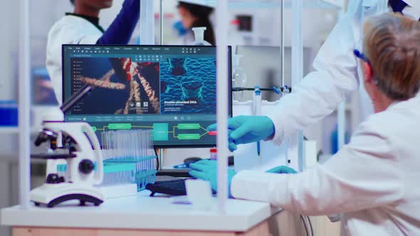 Senior Woaman Biochemist Checking Manifestations of Virus alt