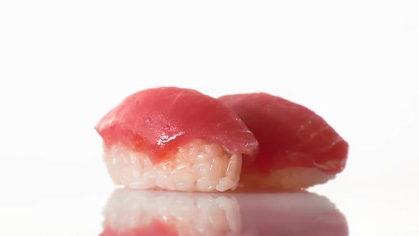 Two Spinning Tuna Sushi Isolated on the White Background. alt