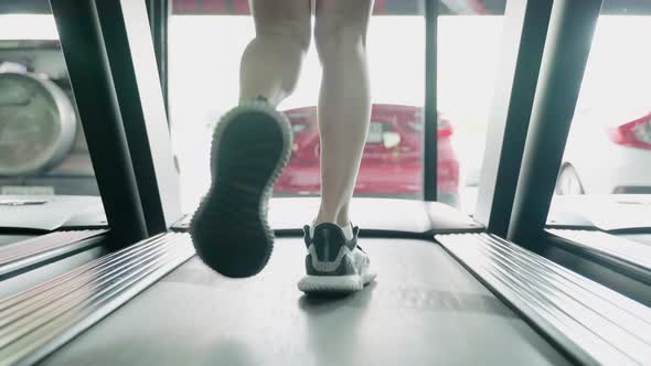 tilt down,Healthy young asian woman are exercising by running on a treadmill.