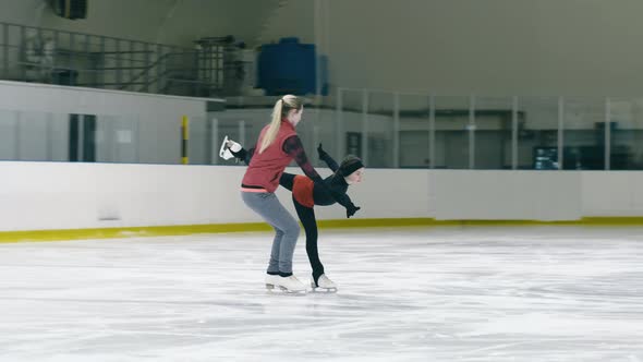 Little girl's figure skating training with coach