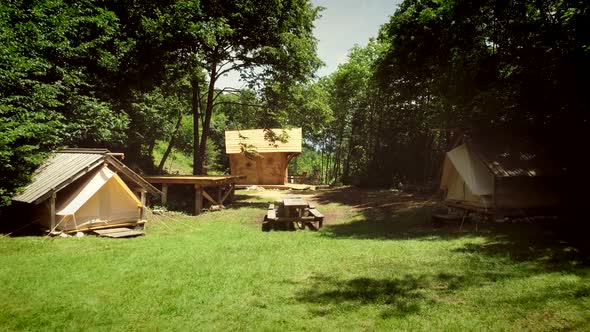 Aerial view of a traditional wooden house in a summer camp located in the forest alt