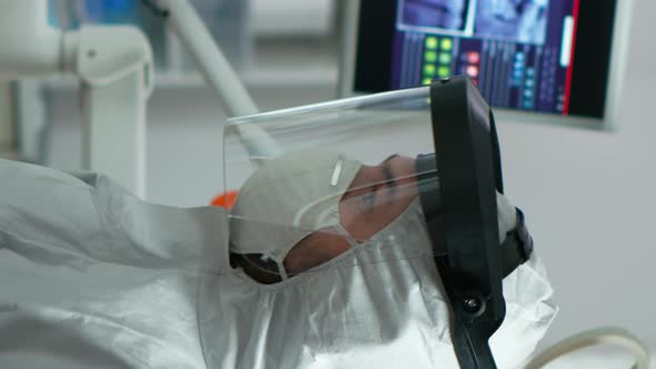 Vertical Video Portrait of Dentist with Protection Mask Speaking with Patient alt