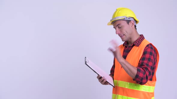 Young Happy Hispanic Man Construction Worker Showing Clipboard and Giving Thumbs Up
