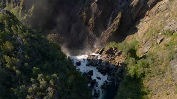 Stomach churning view over the edge of Voringsfossen falls, Norway, drone alt