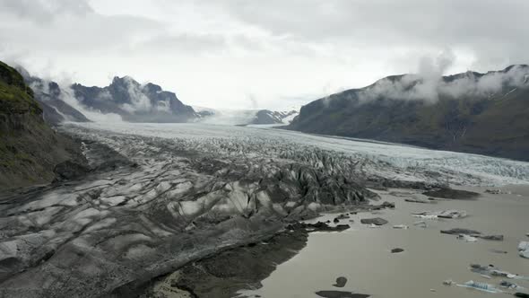 Unique And Natural Glacial Landscape Of Solheimajokull In Iceland - aerial shot alt