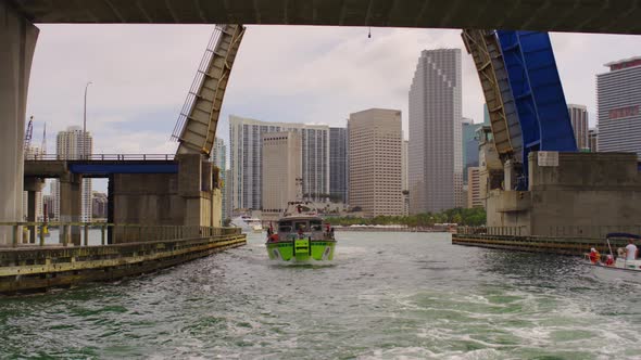 Boat floating under a bascule bridge in Miami alt