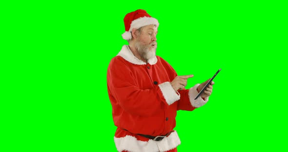 Santa claus using digital tablet alt