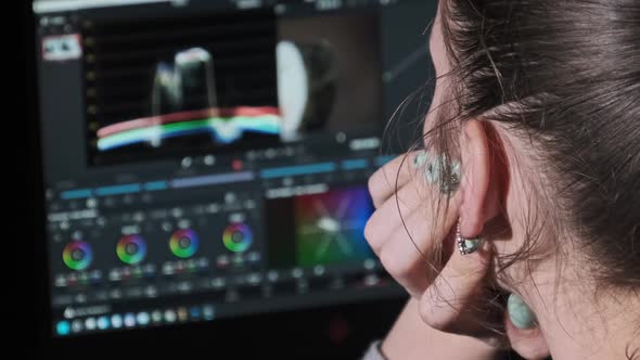Woman Video Editor Sits at a Laptop and Processes Video Material at Home alt