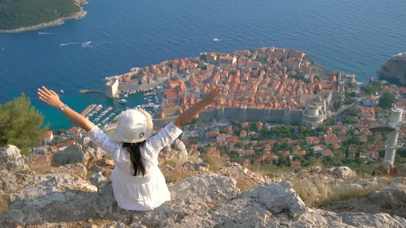 Woman Tourist Looking at City of Dubrovnik Croatia alt