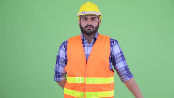 Happy Young Overweight Bearded Indian Man Construction Worker with Ok Sign alt