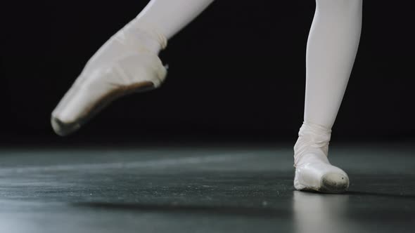 Closeup Female Legs in White Tights and Punts of Ballet Shoes Doing Dance Exercises Pulling alt