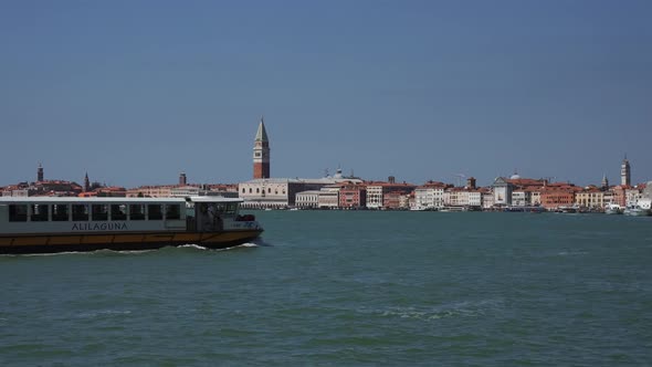 Boats Passing Venice Lagoon with a Magical St alt
