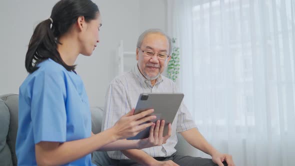 Asian nurse showing health checkup report to grandfather and giving advice