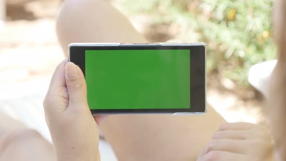 Deck chair outdoor woman relaxing with green screen tablet 4K 2160p 30fps UHD footage - Young female alt